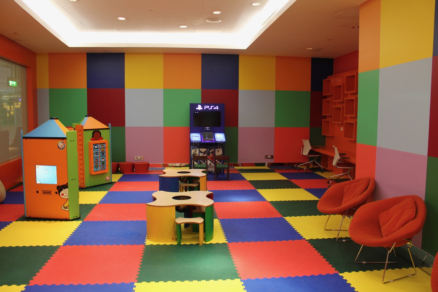a colorful room with tables and chairs