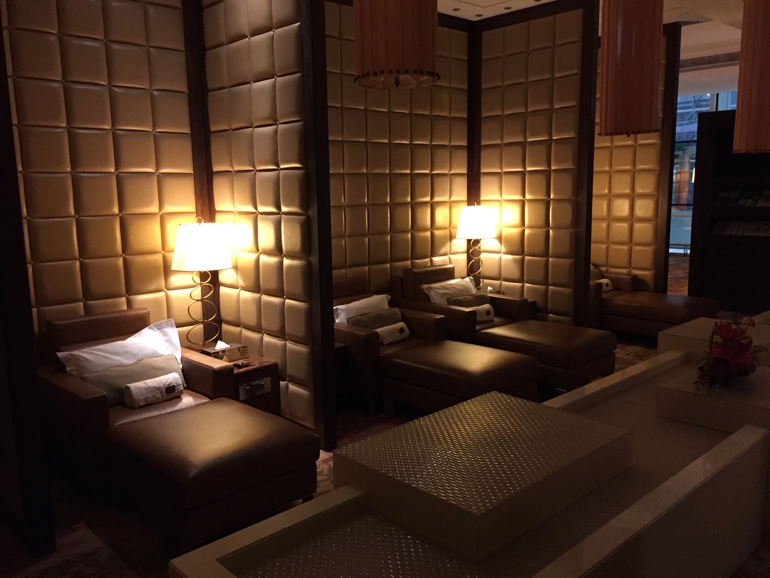 a room with leather chairs and lamps