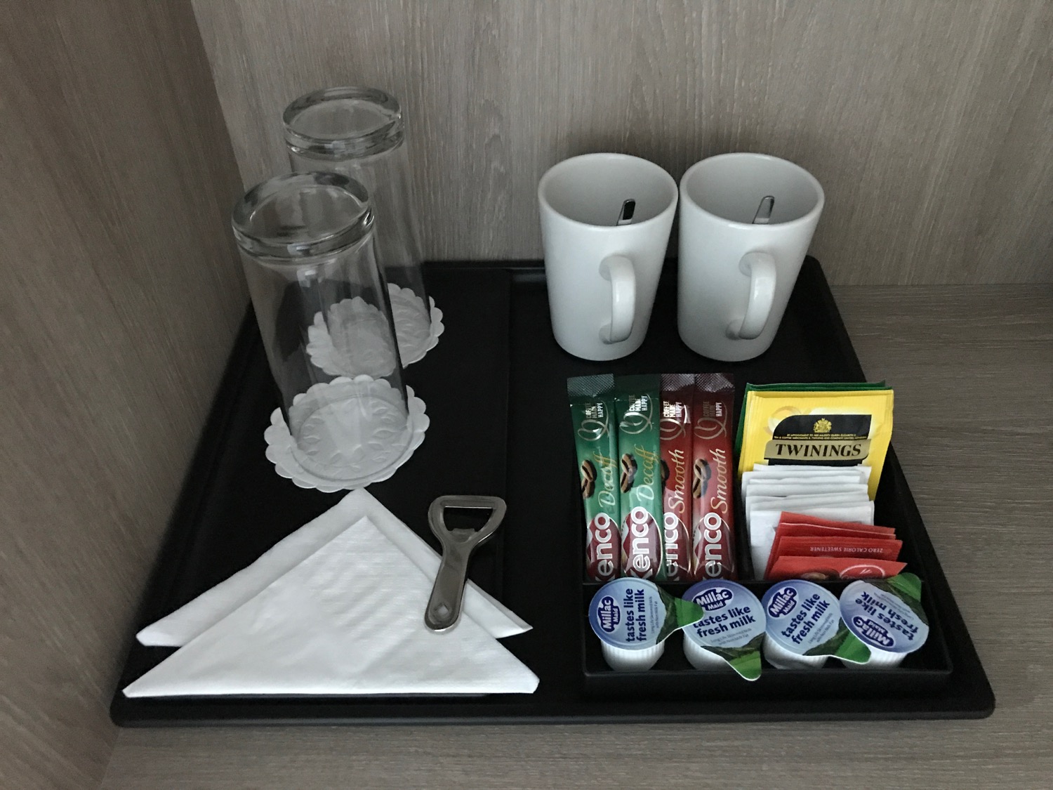 a tray with cups and tea bags on it