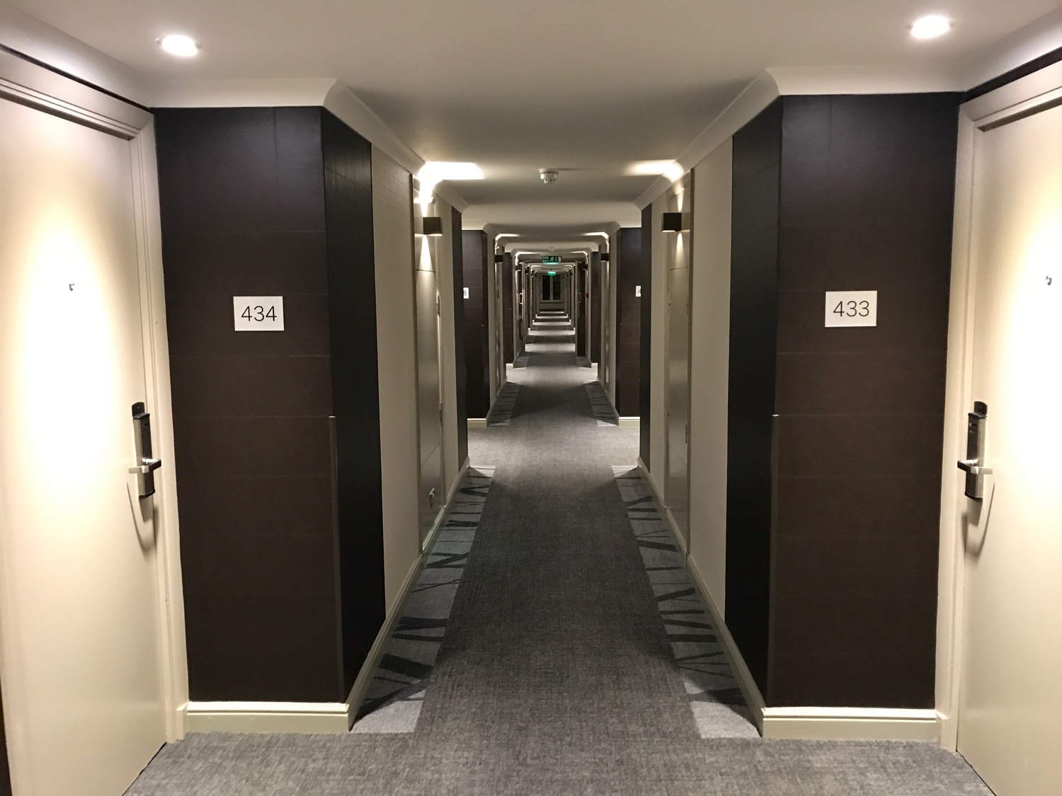a hallway with a door and a number on the wall