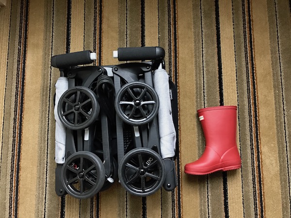 The GB Pockit Stroller fully folded and next to a toddler rain boot for size.