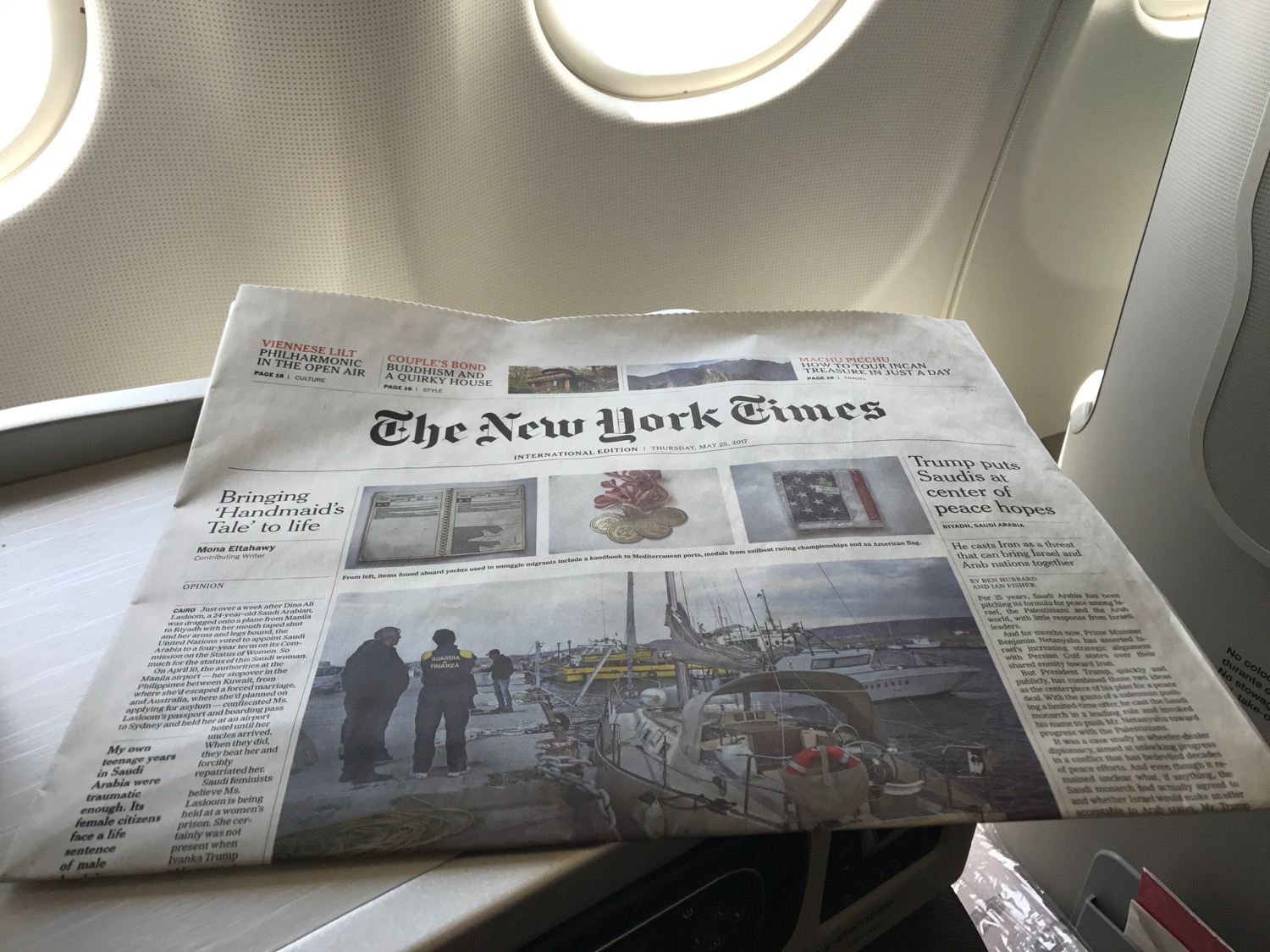 a newspaper on a plane