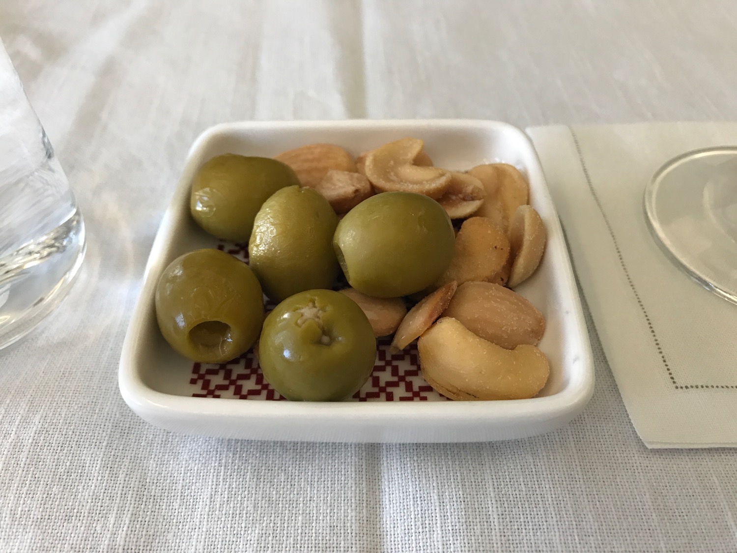 a bowl of nuts and olives