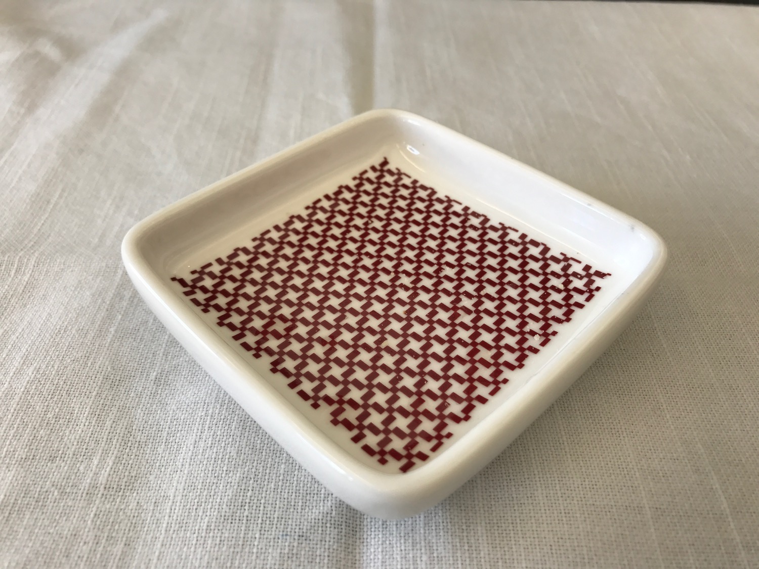 a small square white and red dish