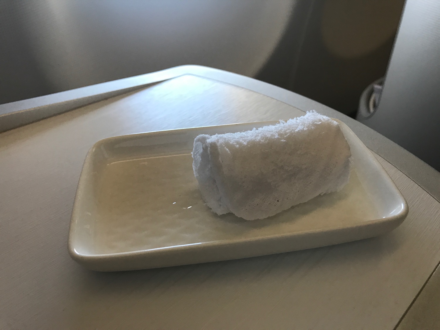 a rolled up white object on a white plate