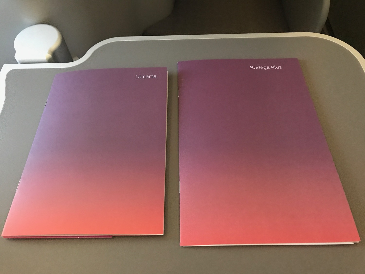 a pair of purple and pink folders on a table