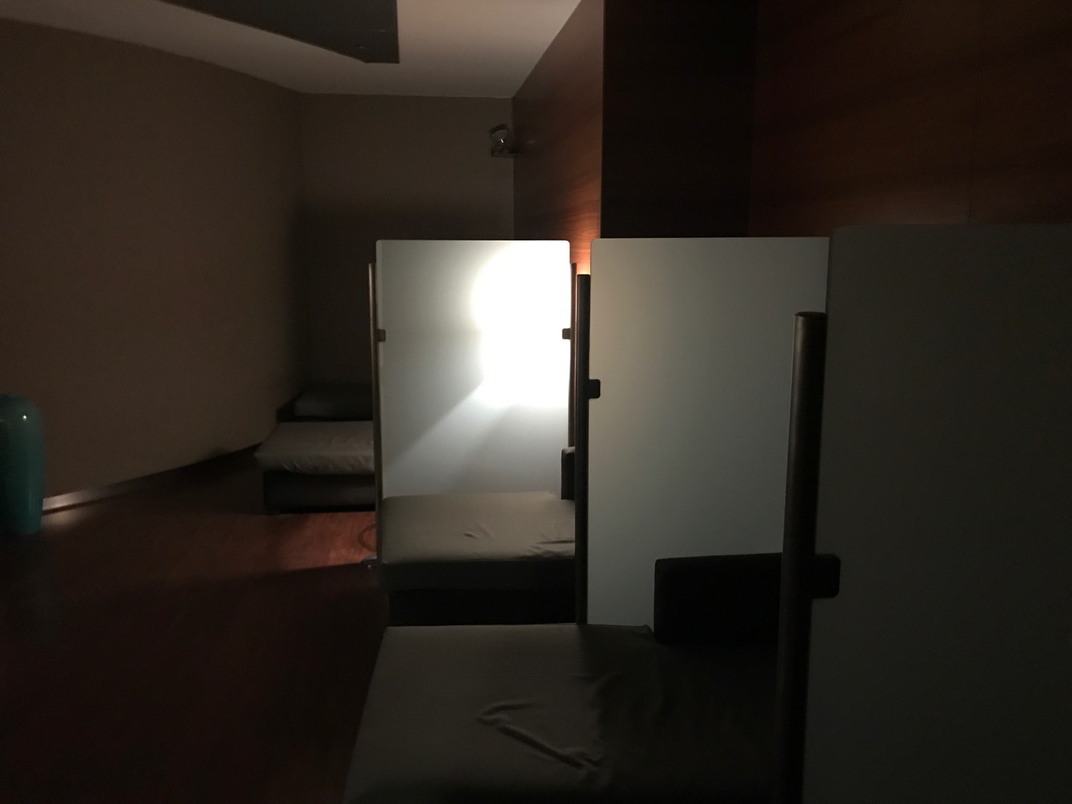 a room with two beds and a light in the background