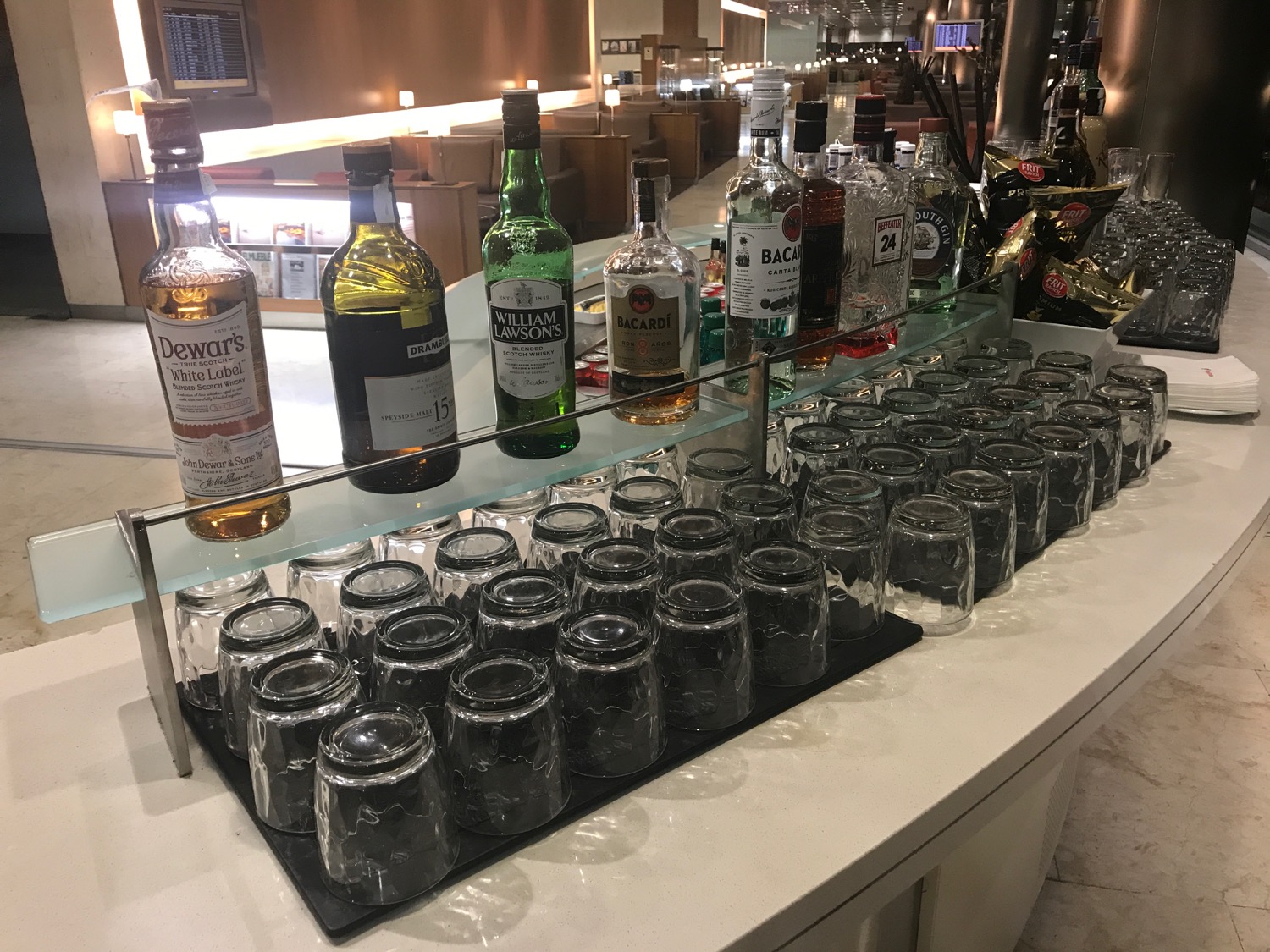 a row of glasses and bottles on a counter