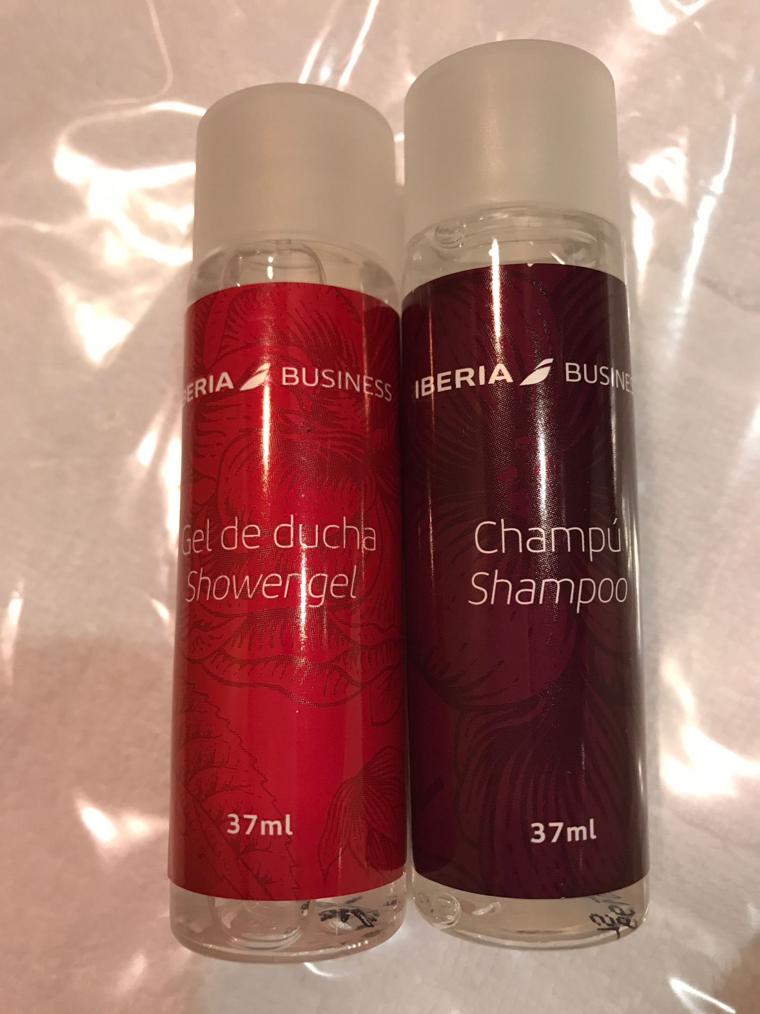 two bottles of shampoo on a white surface