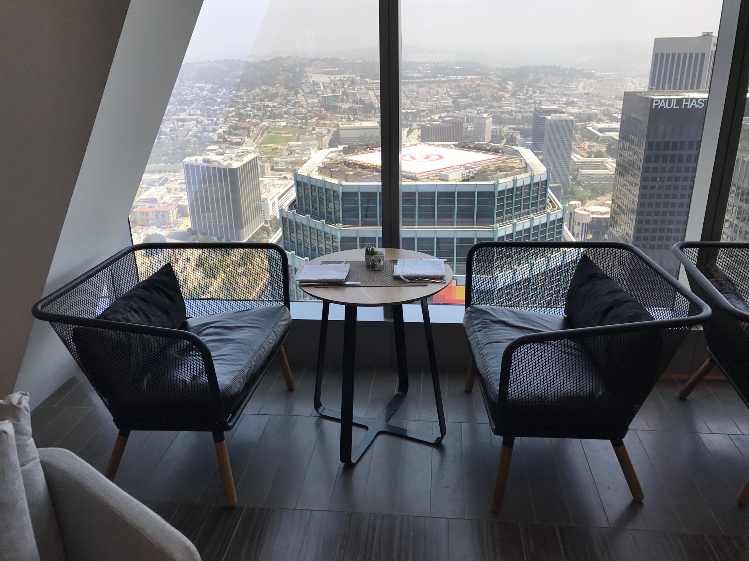 a room with a table and chairs and a view of a city