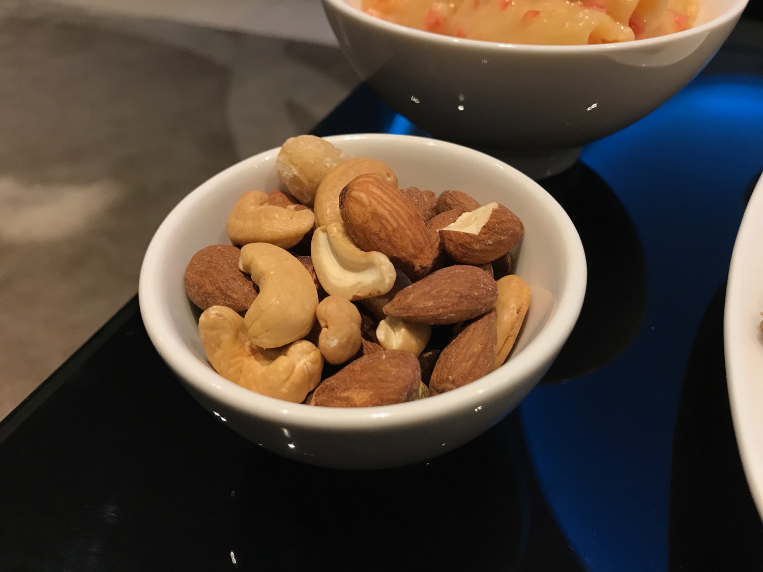 a bowl of nuts and a bowl of pasta