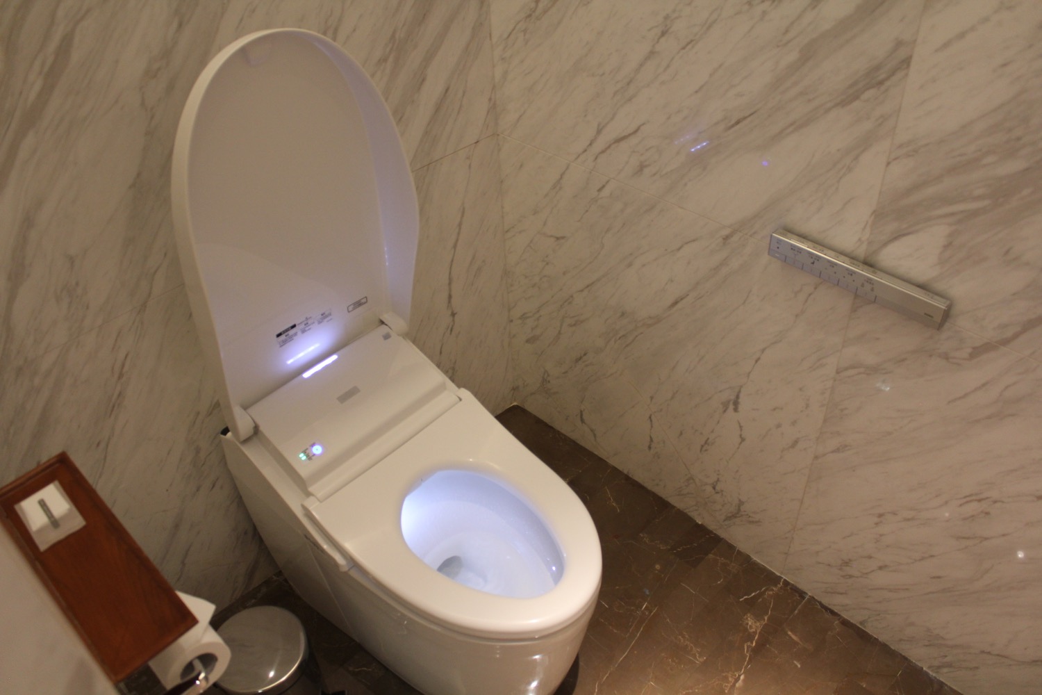 a toilet with a light in the lid