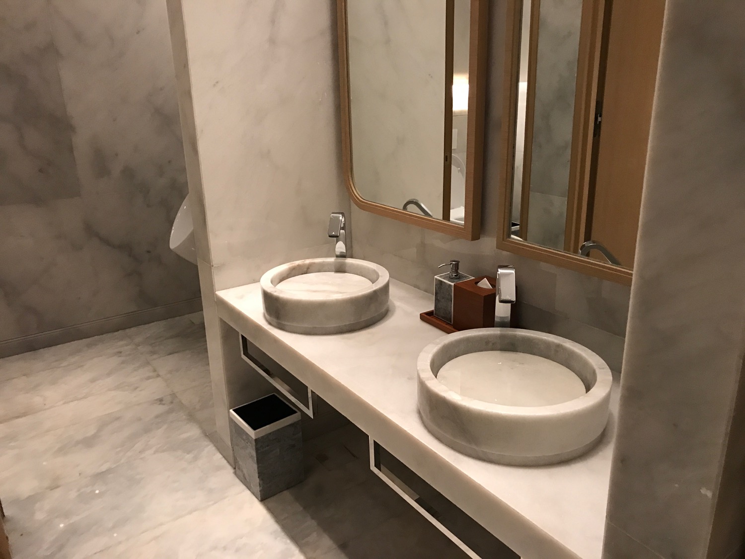 a bathroom with marble sinks and mirrors
