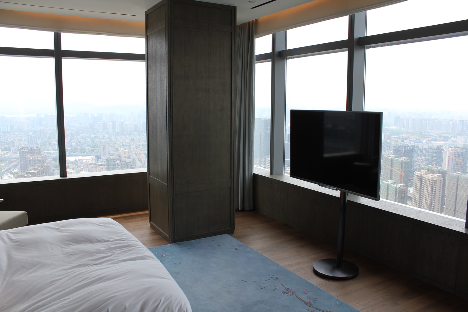 a room with a television and a large window