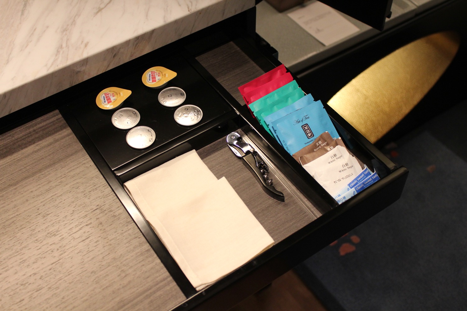a black drawer with a tray of condiments and a napkin