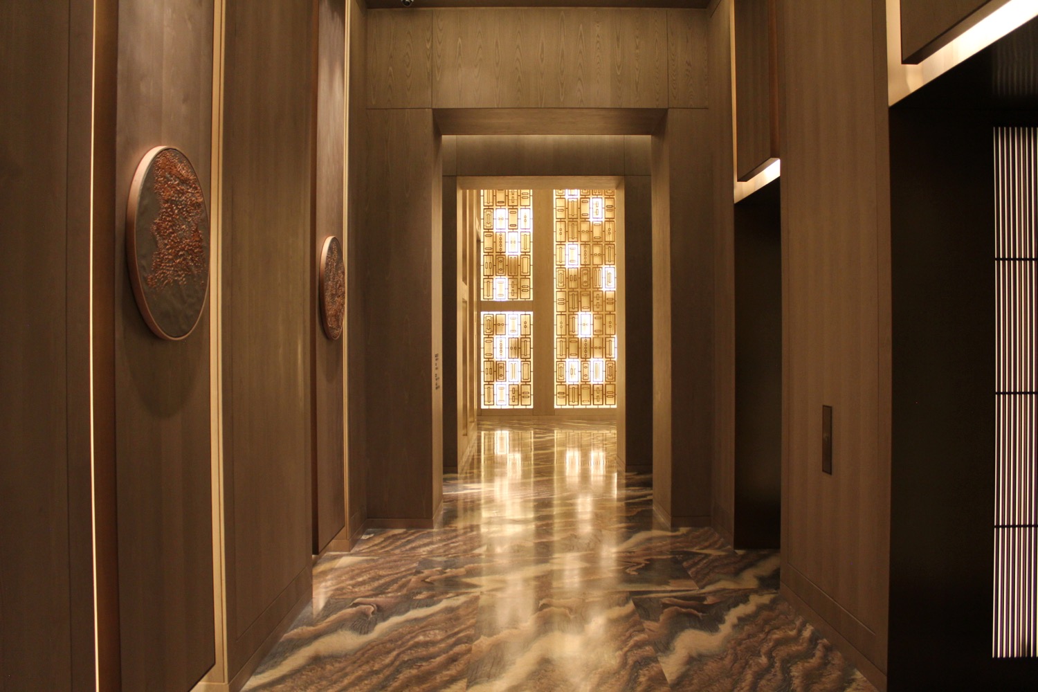 a hallway with marble floor and a marble floor