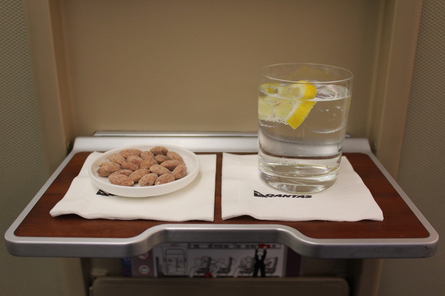a plate of food and a glass of water on a tray