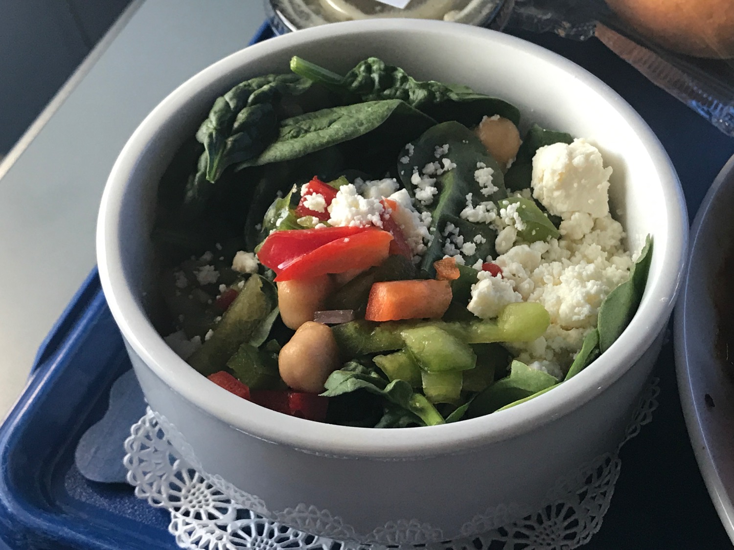 a bowl of salad with vegetables and cheese