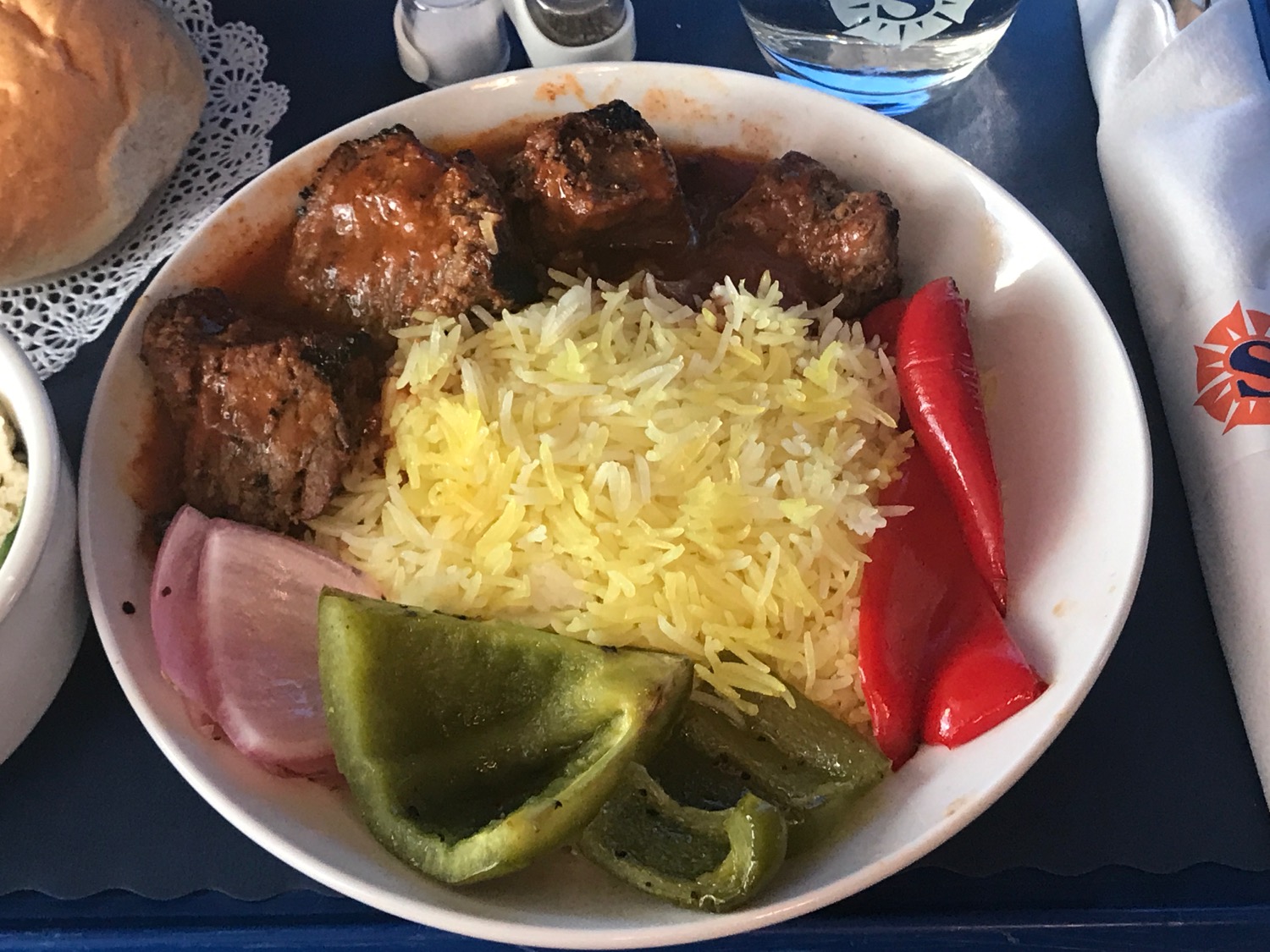 a bowl of rice and meat with peppers