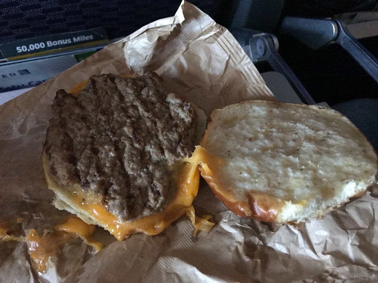 a burger with cheese on a bagel