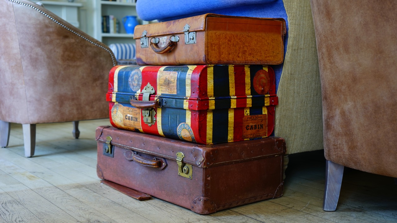 a stack of suitcases on a wood floor