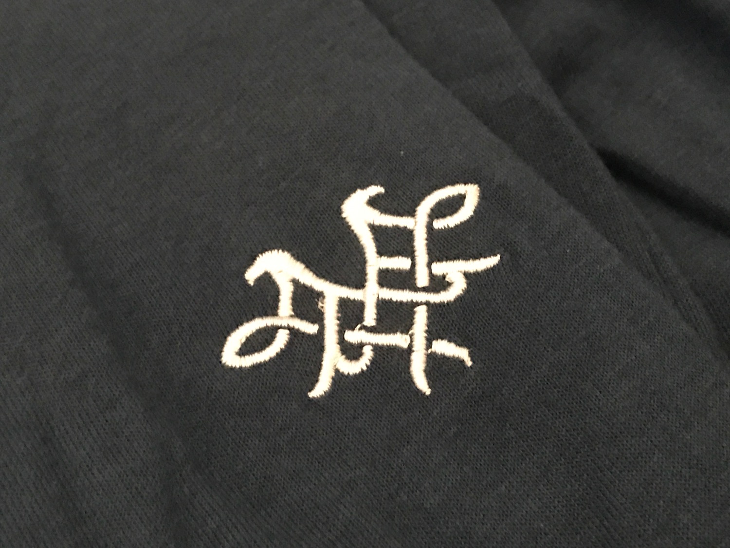 a black fabric with a white logo