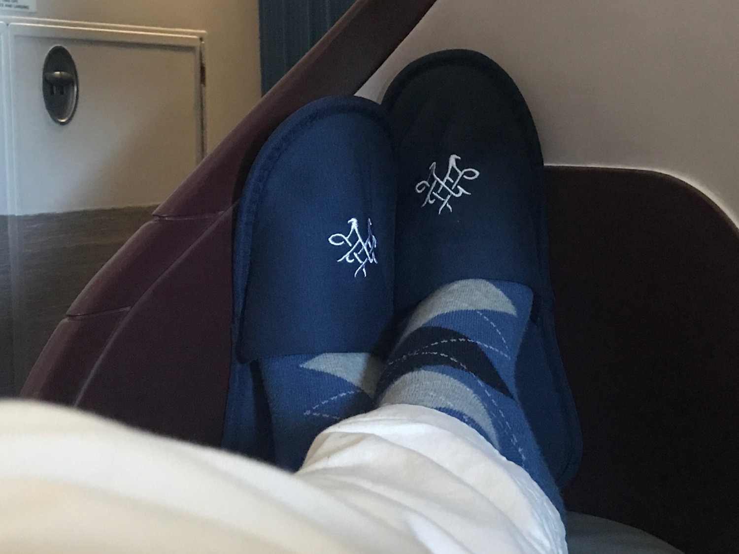 a person's feet wearing blue slippers