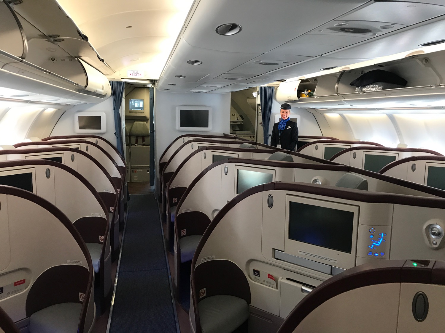 an airplane with rows of seats and a man standing in the middle