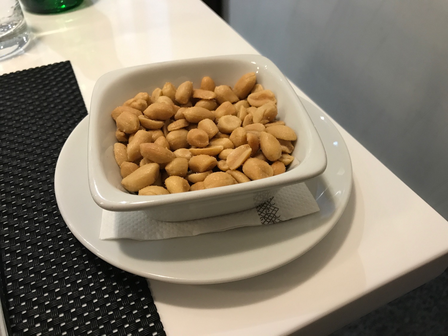 a bowl of peanuts on a plate