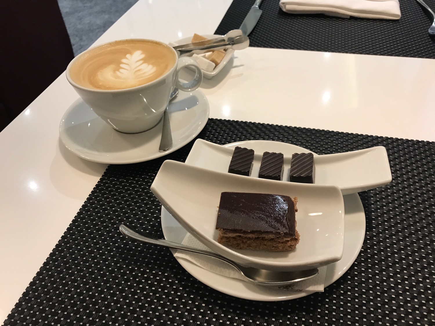 a plate of chocolate cake and a cup of coffee