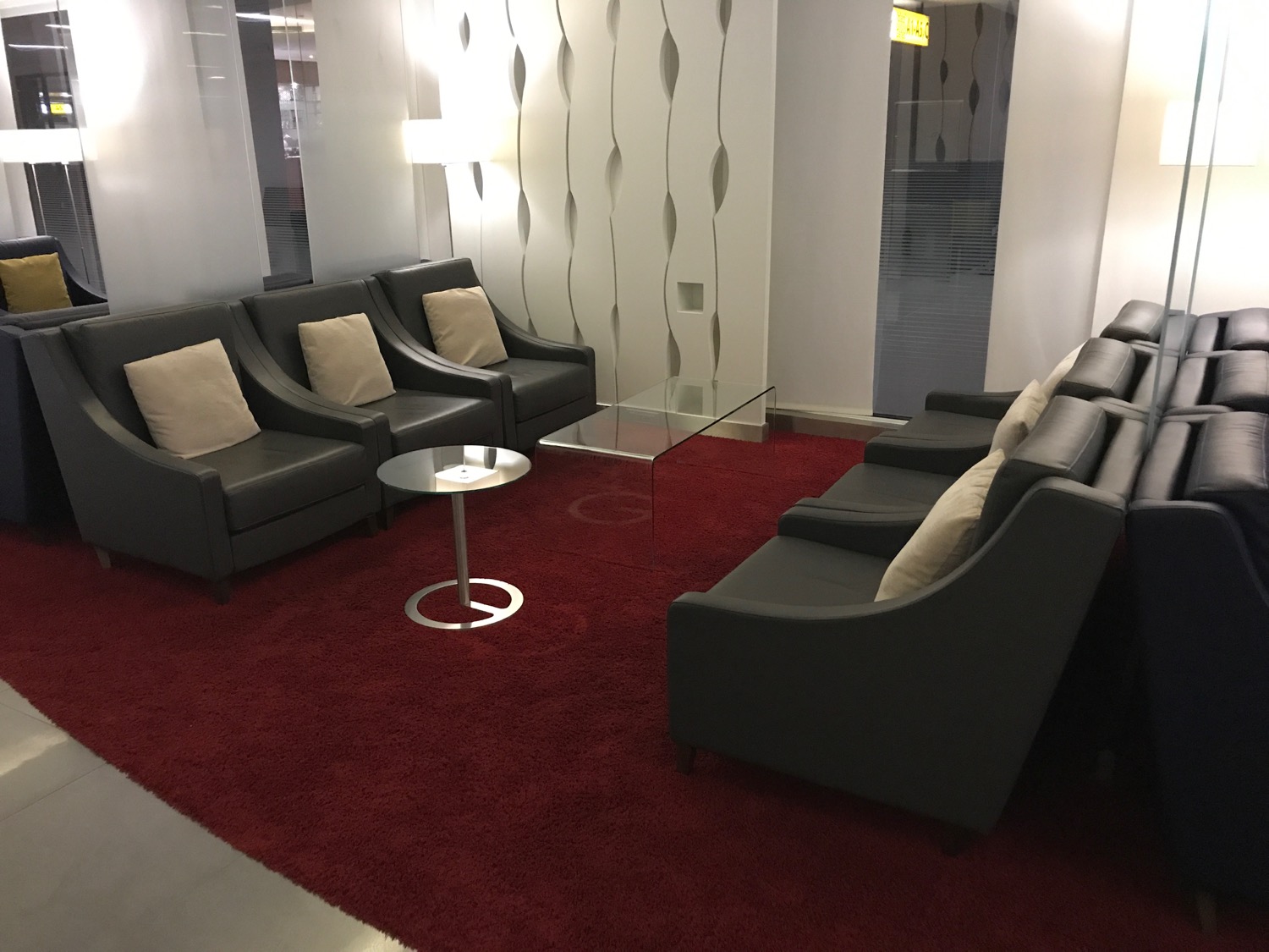 a room with a red carpet and chairs