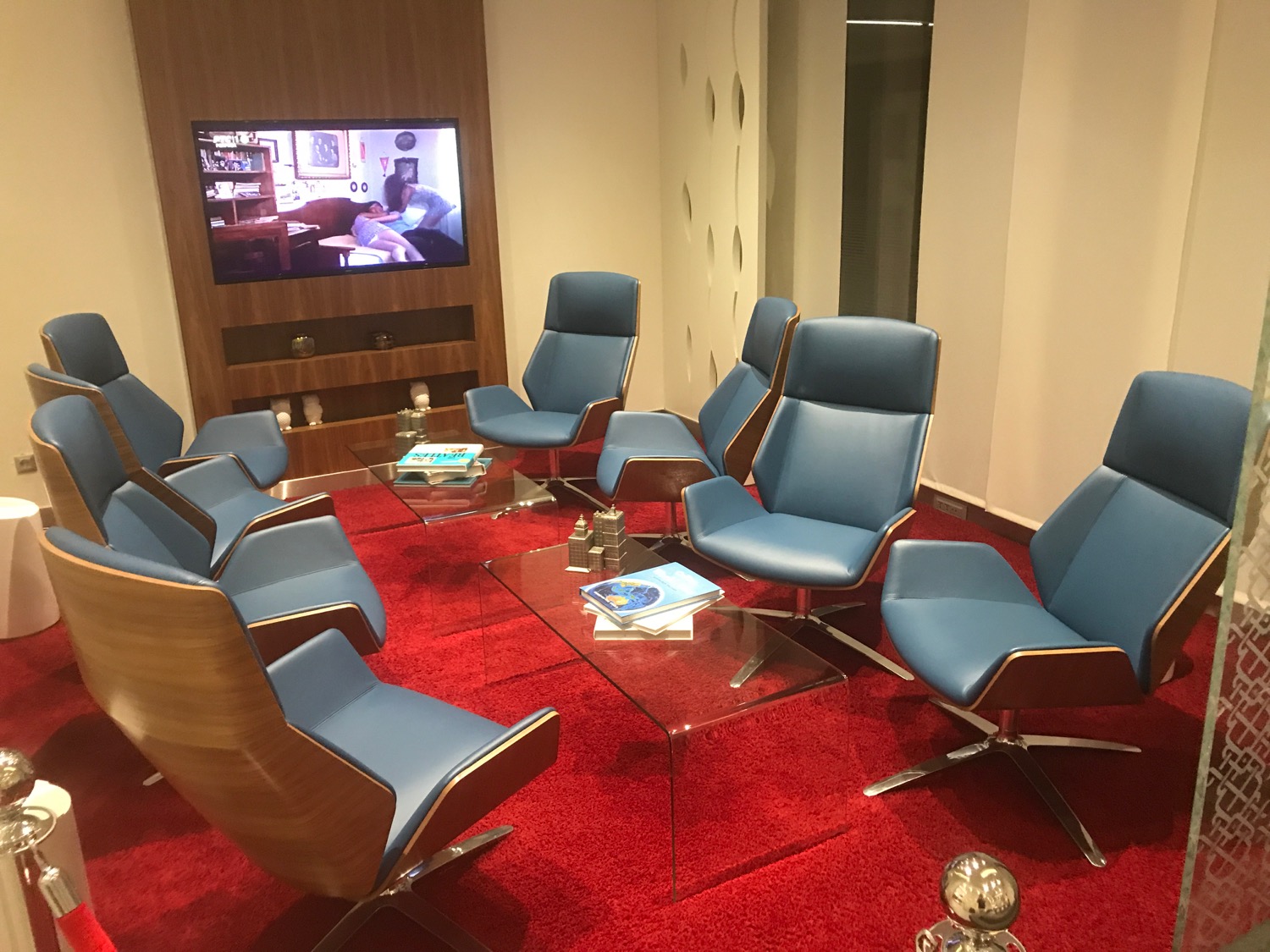 a group of blue chairs in a room with a television