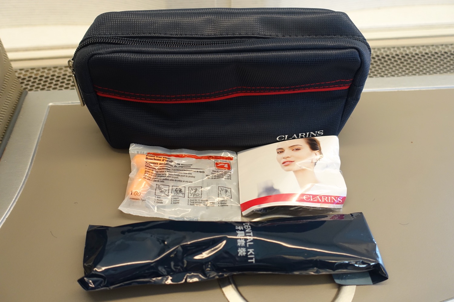 a small black bag with a package of makeup and a picture of a woman