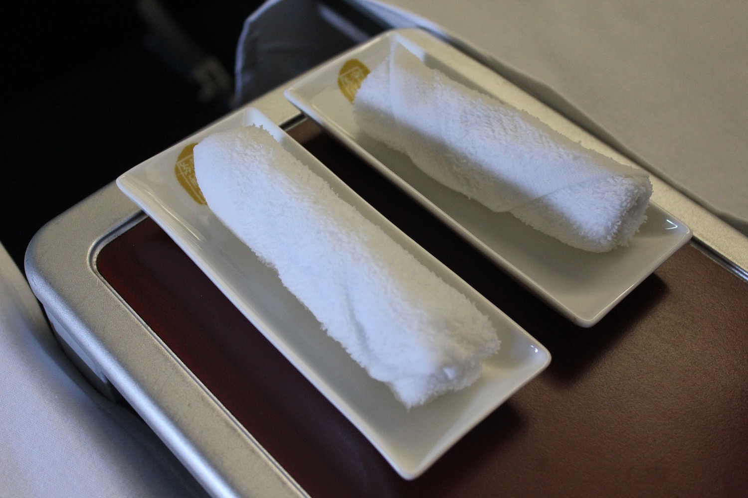 two plates with rolled up towels on them