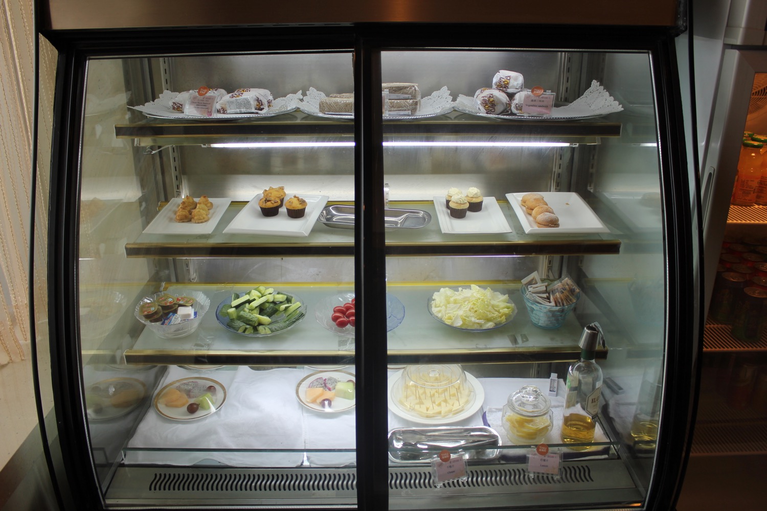 a glass case with food on it