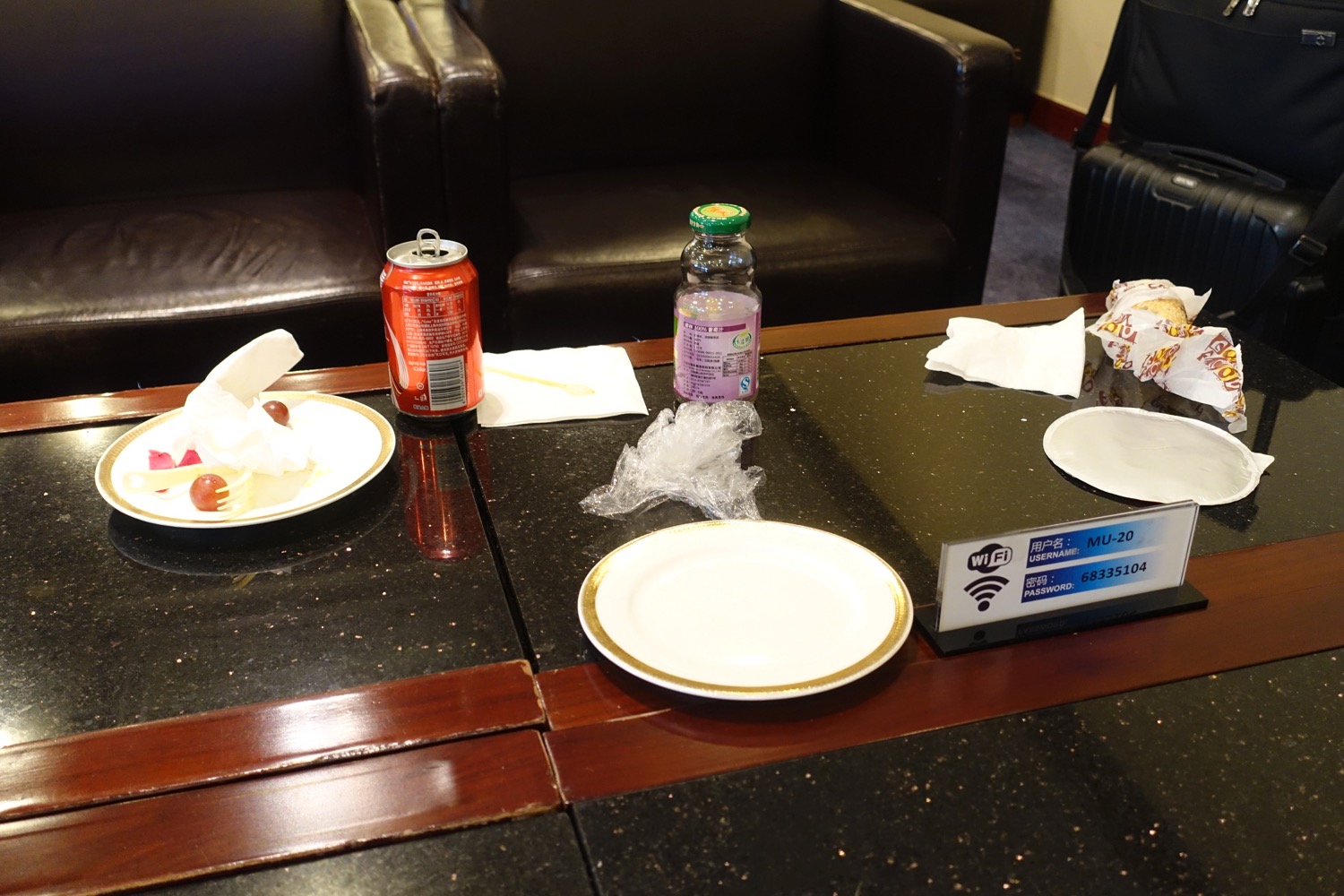 a table with plates and a soda on it