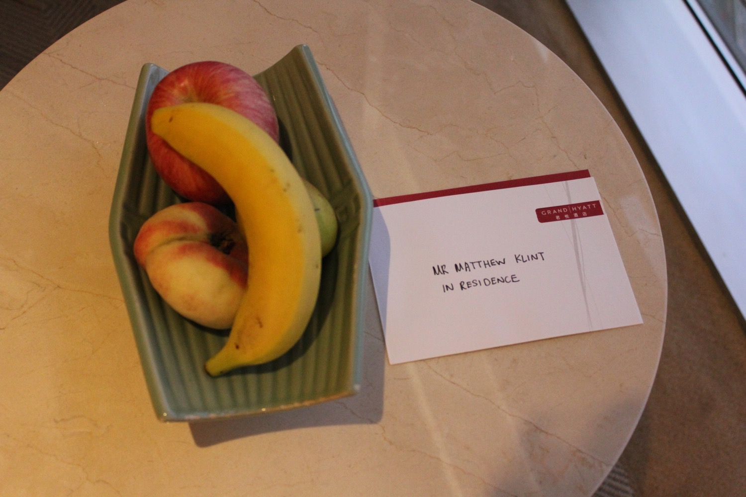a bowl of fruit and a note