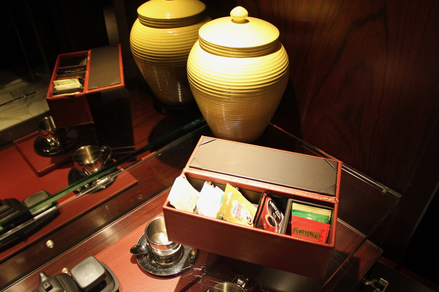a box with tea packets and a couple of yellow ceramic jars