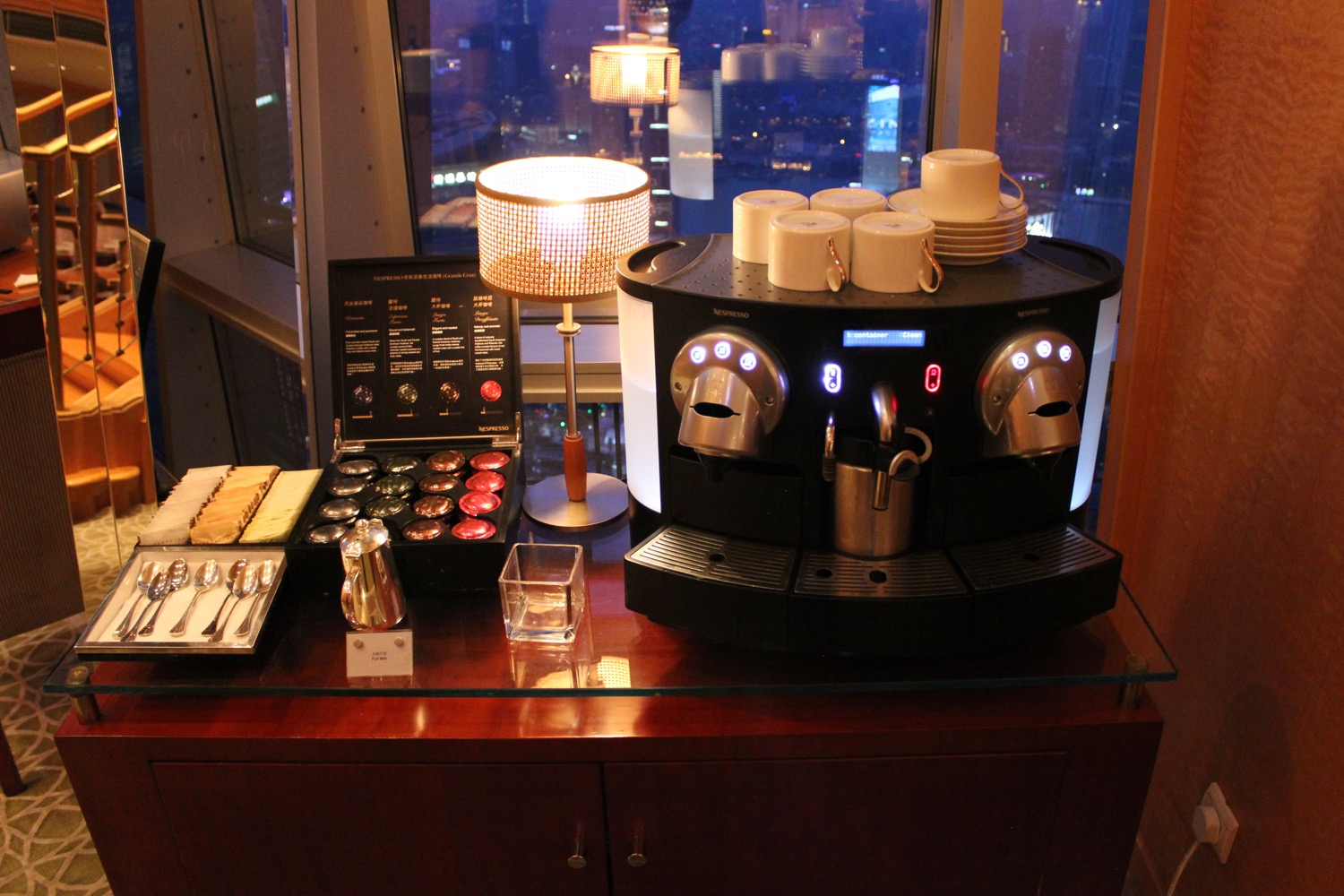 a coffee machine with cups and plates on a table