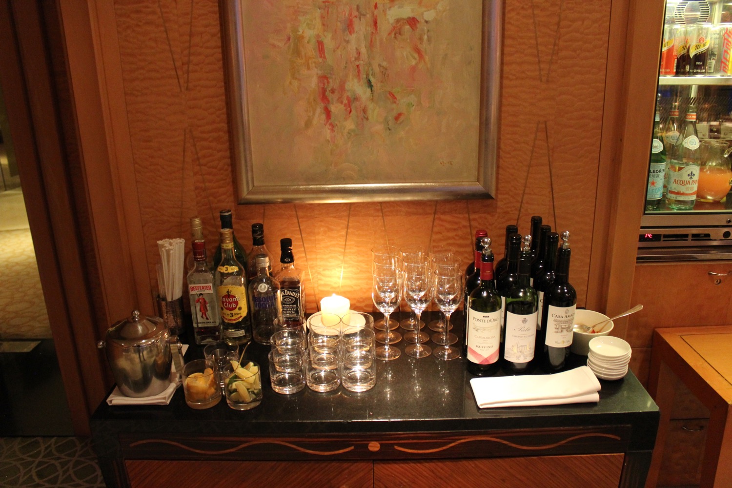 a table with wine bottles and glasses