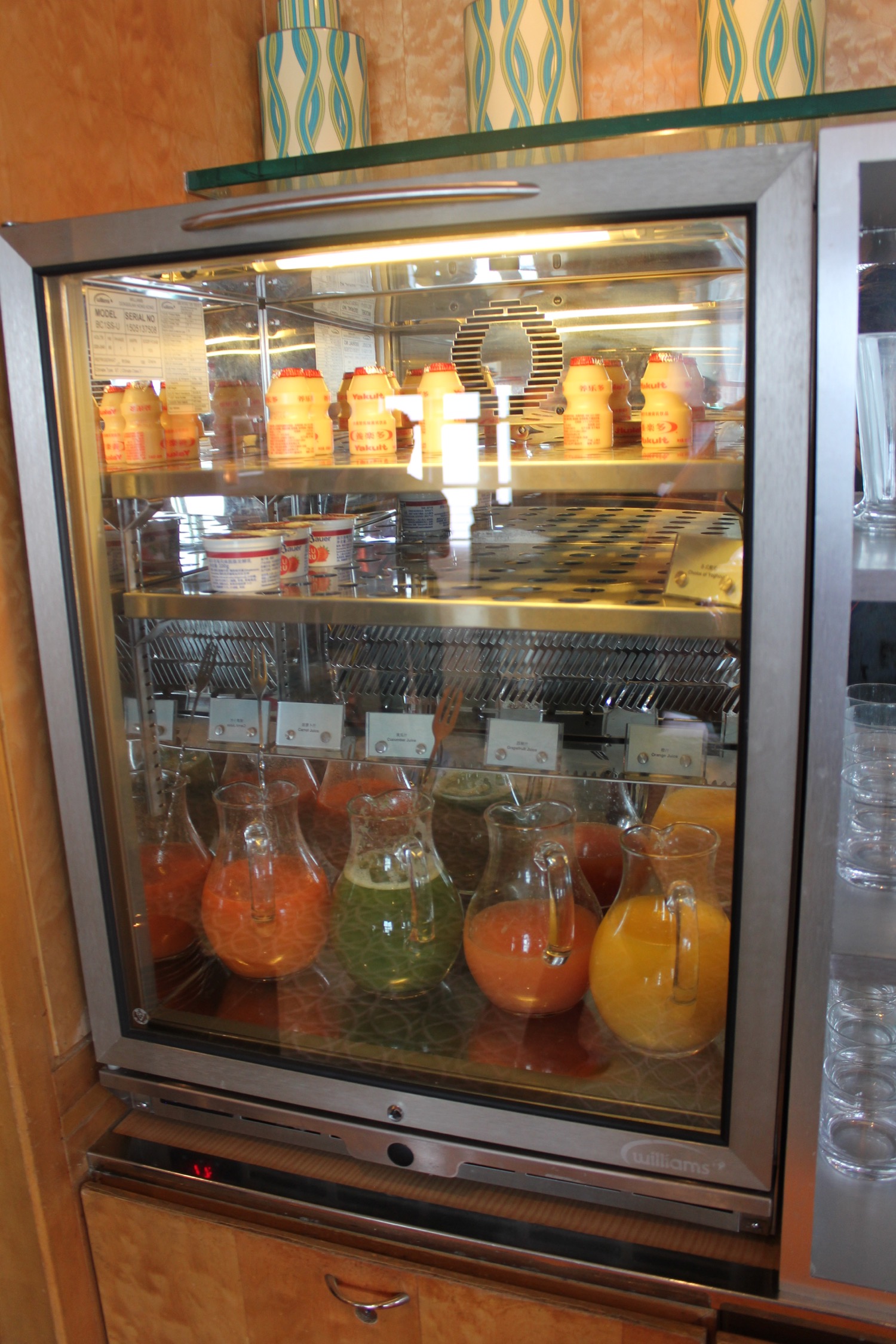 a glass case with different drinks in it