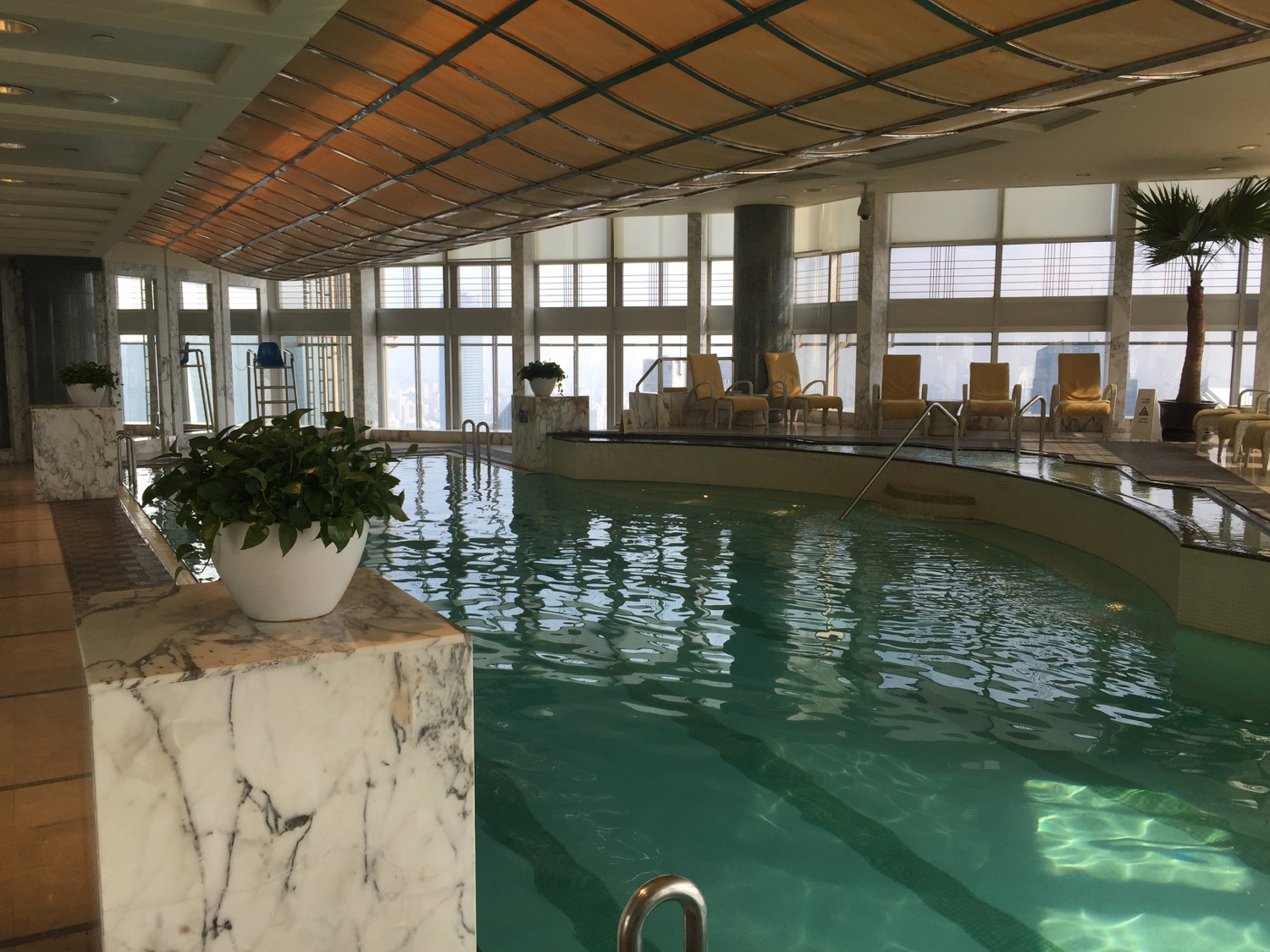 a indoor pool with a large pool and a large window