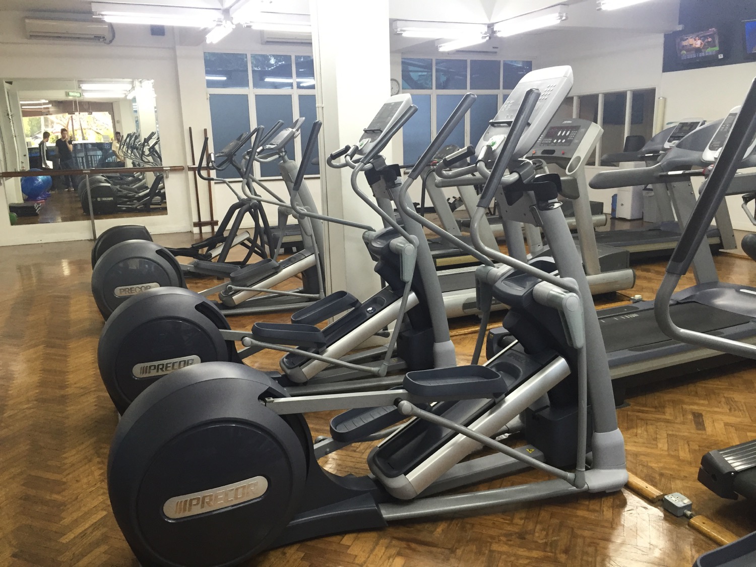 a group of exercise machines in a gym