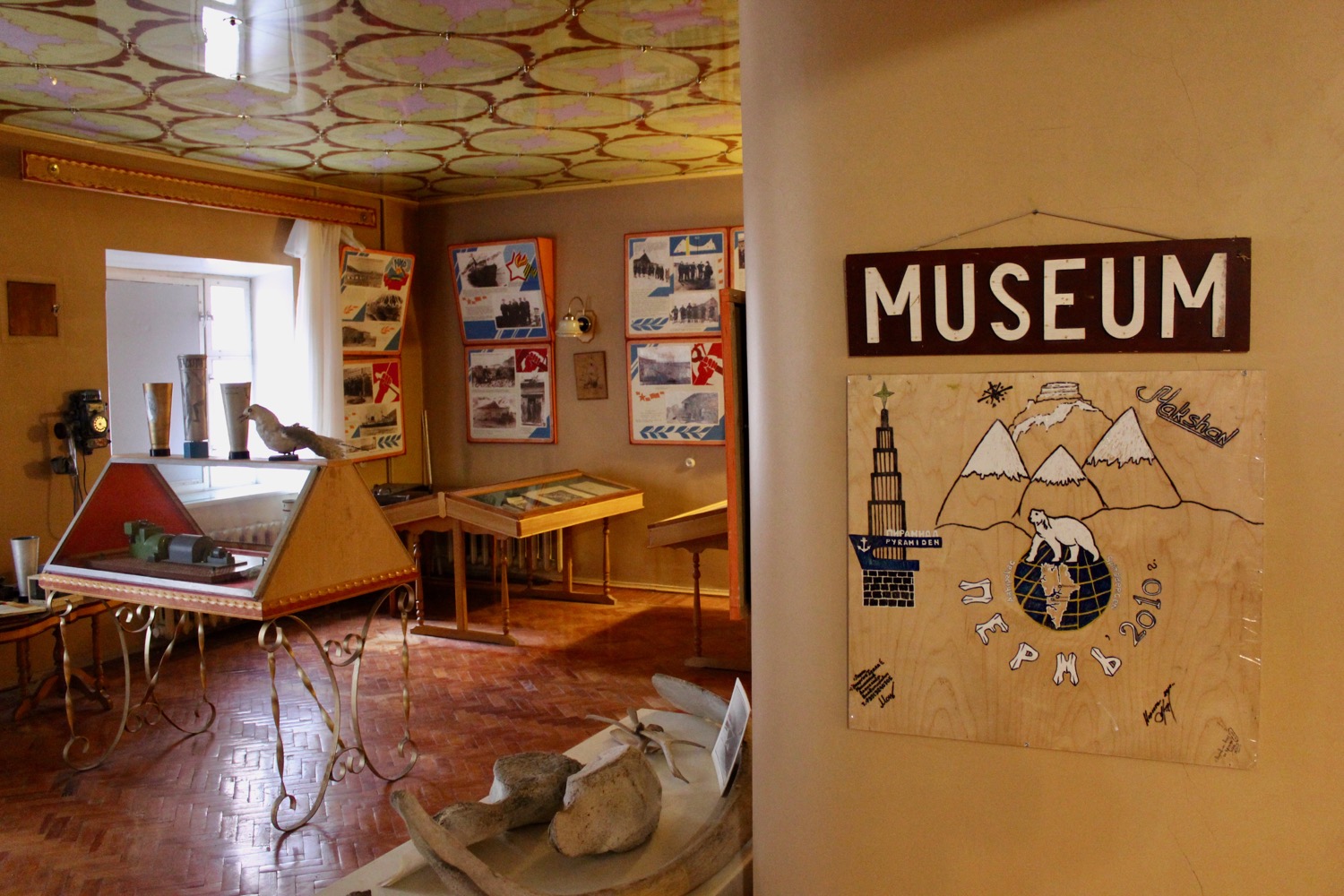 a room with a museum sign and pictures