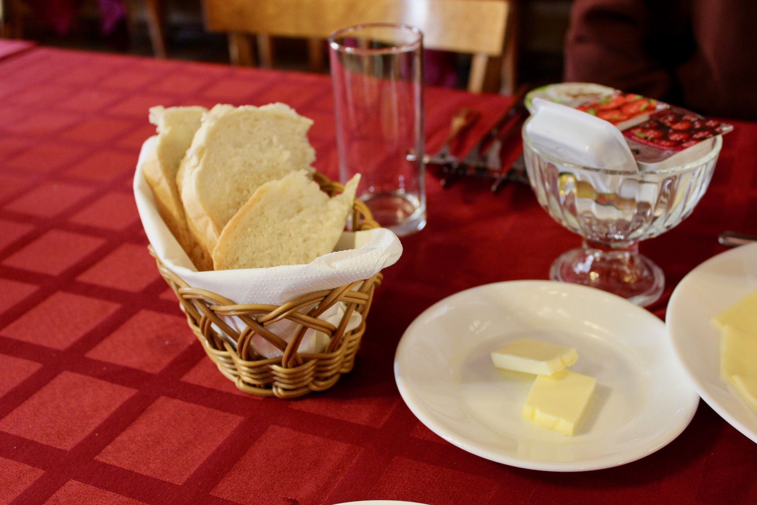 a basket of bread and butter on a plate