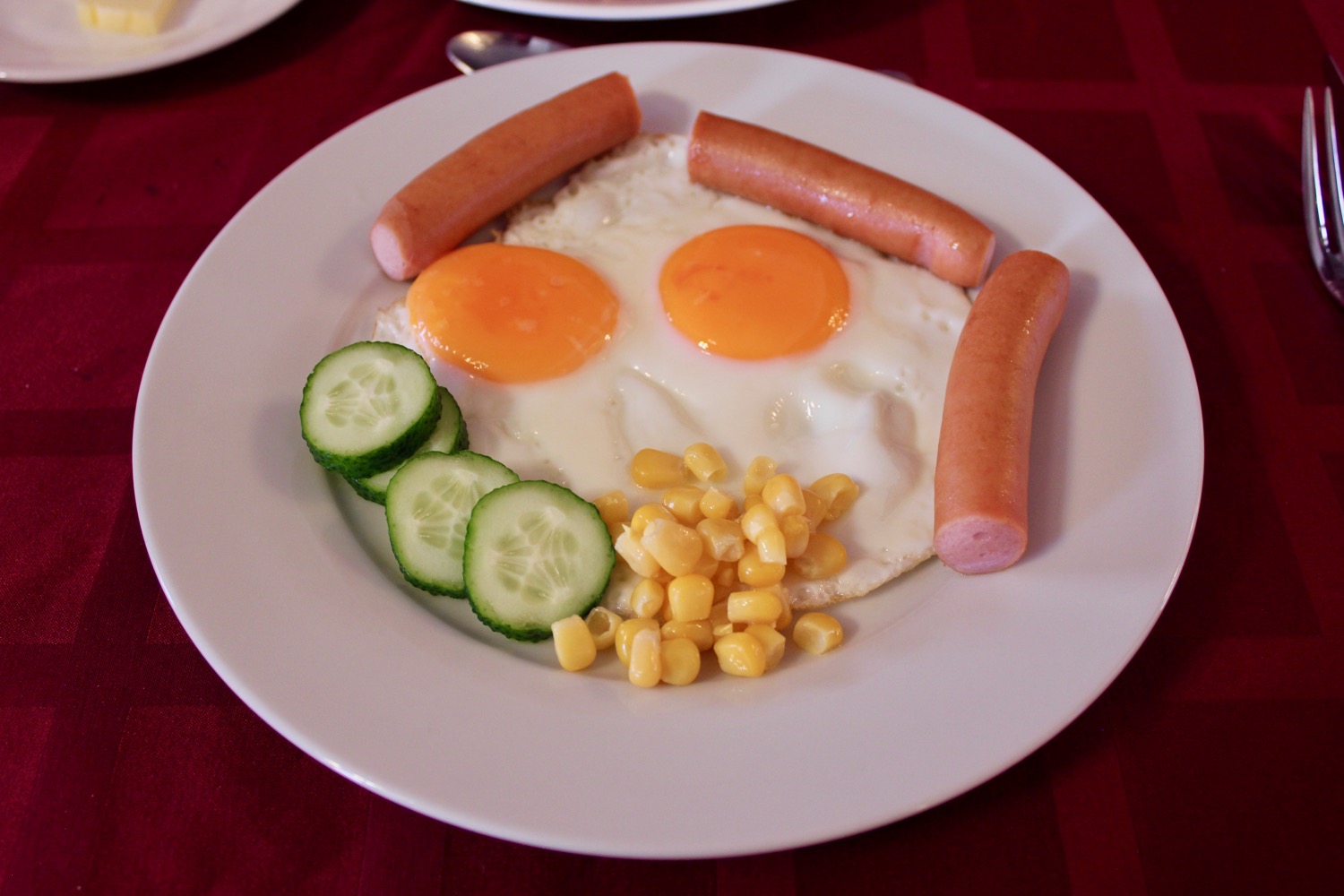 a plate of food with eggs and sausages