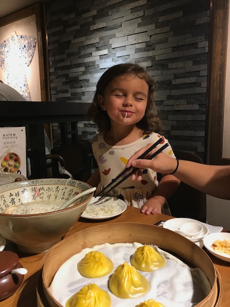 a child eating food at a table