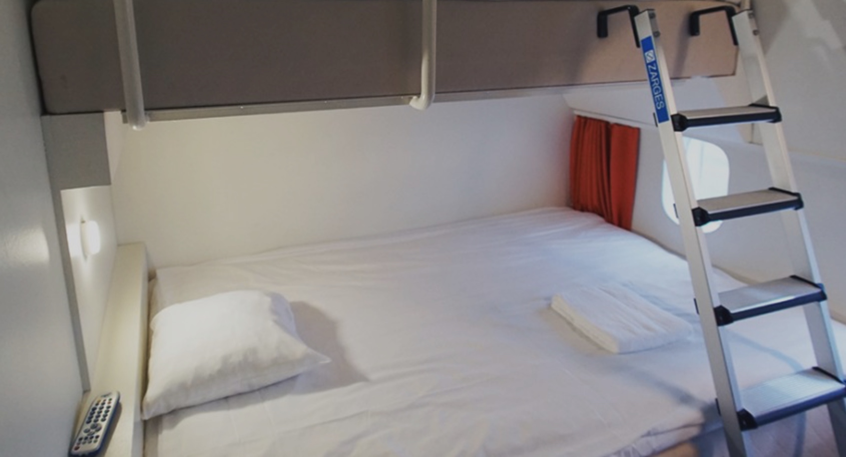 a bed with white sheets and a white pillow