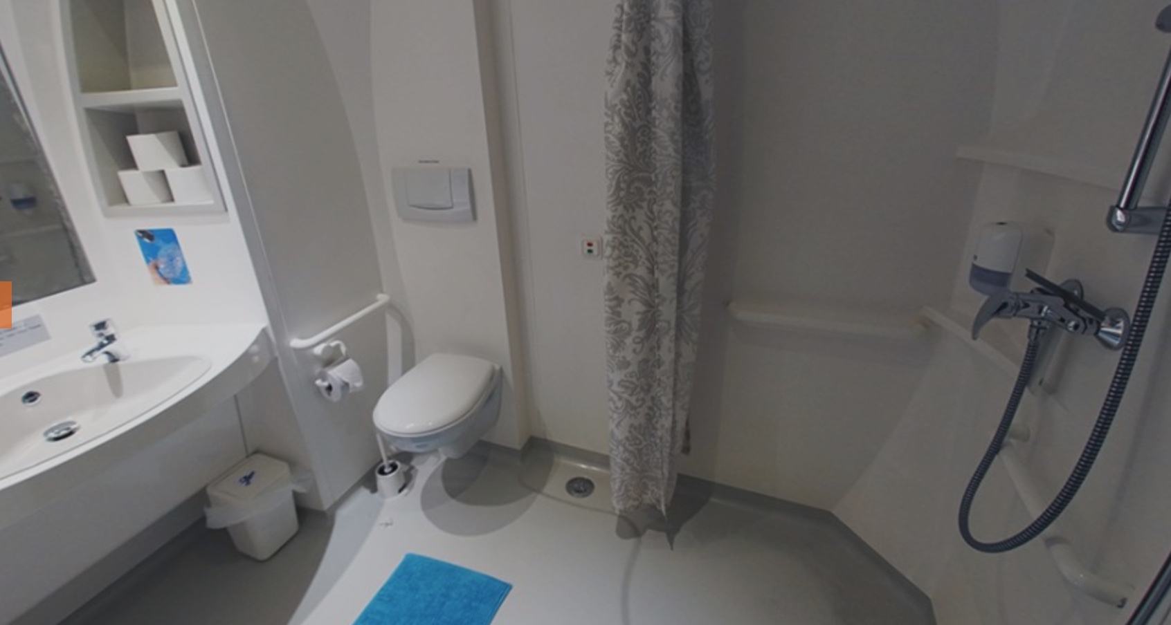 a bathroom with a shower curtain and a toilet