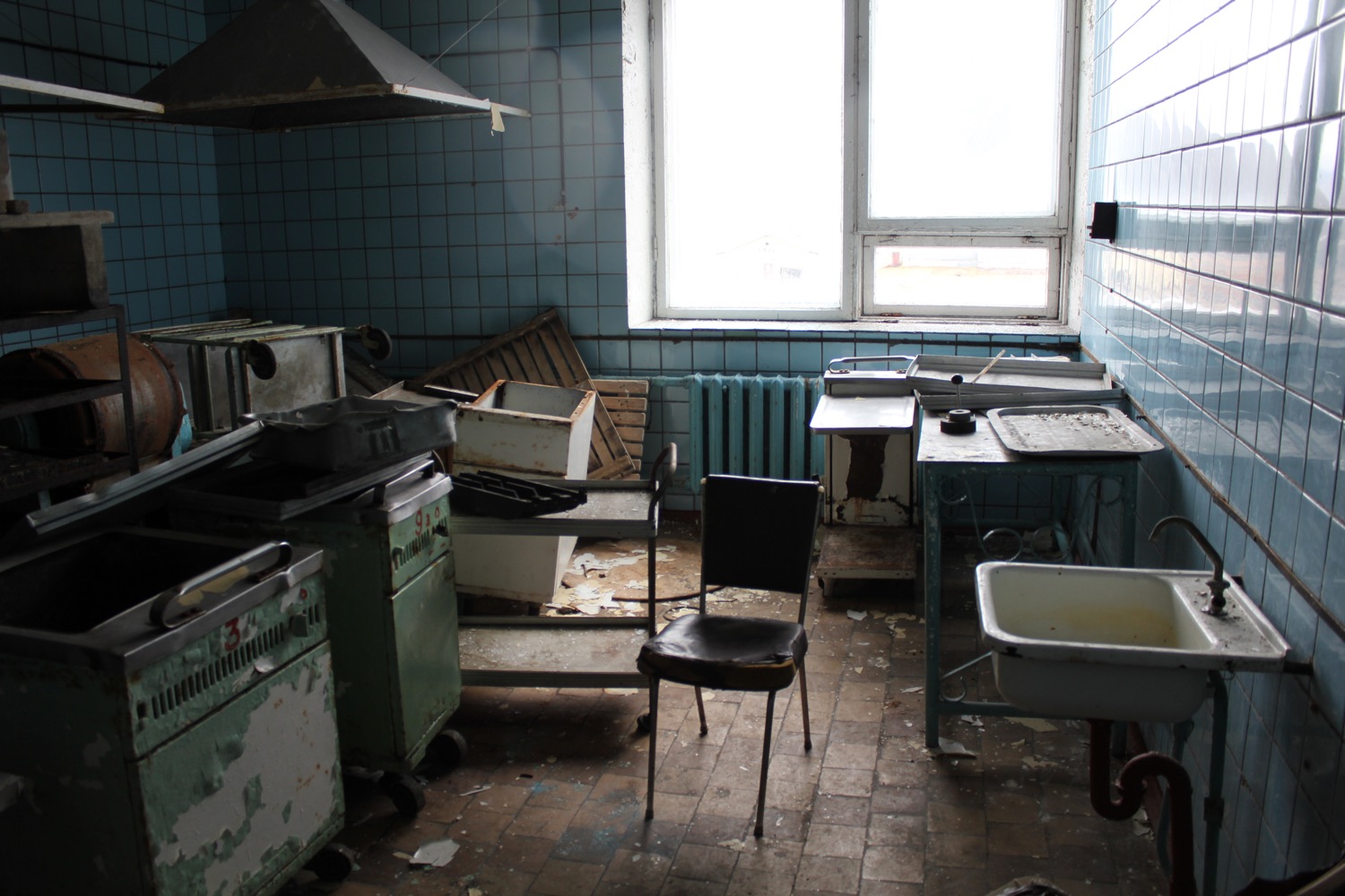 a kitchen with a chair and a sink